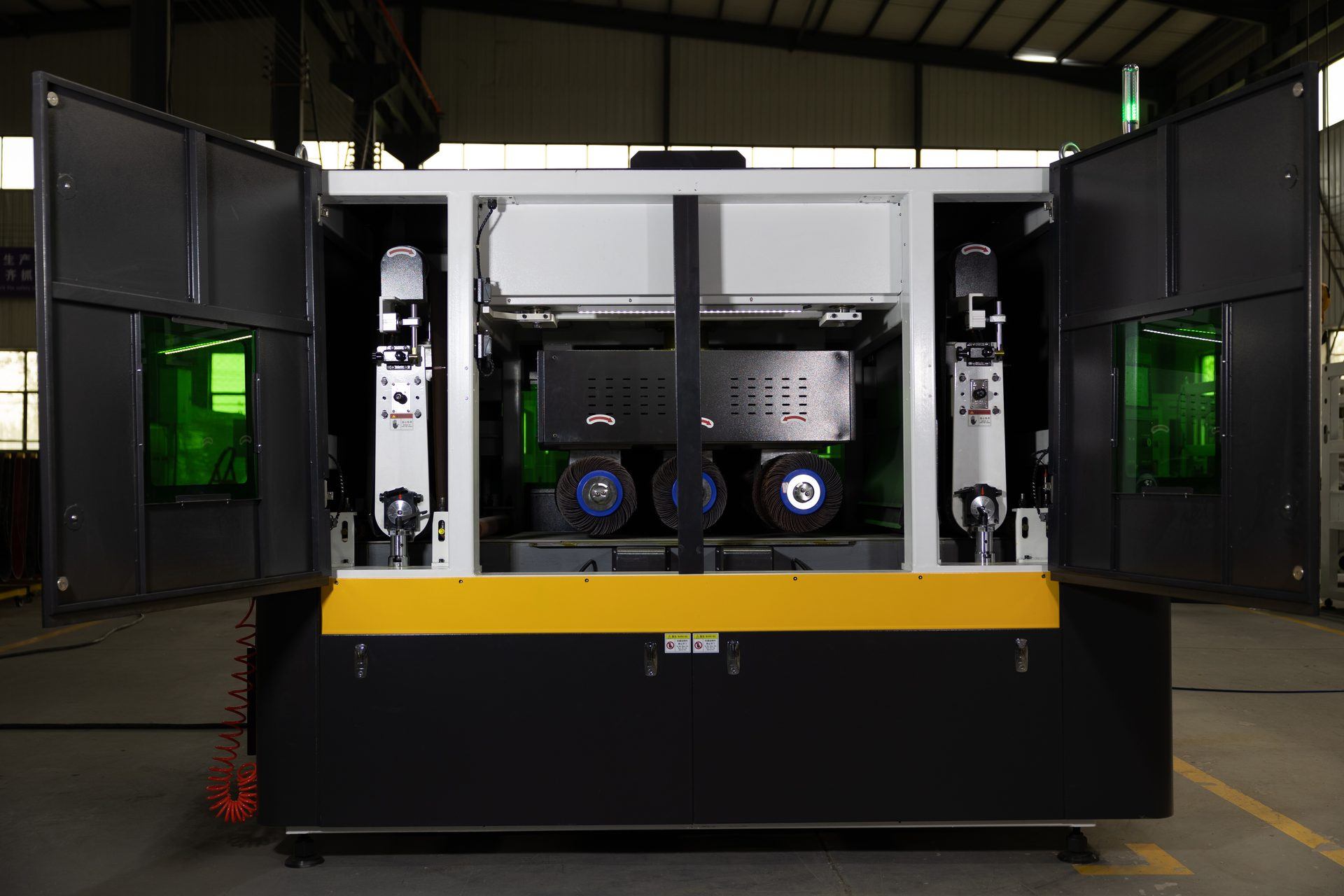 Inside a Lasvio BRB deburring machine showing the abrasive belt, rotary brush and second belt stations